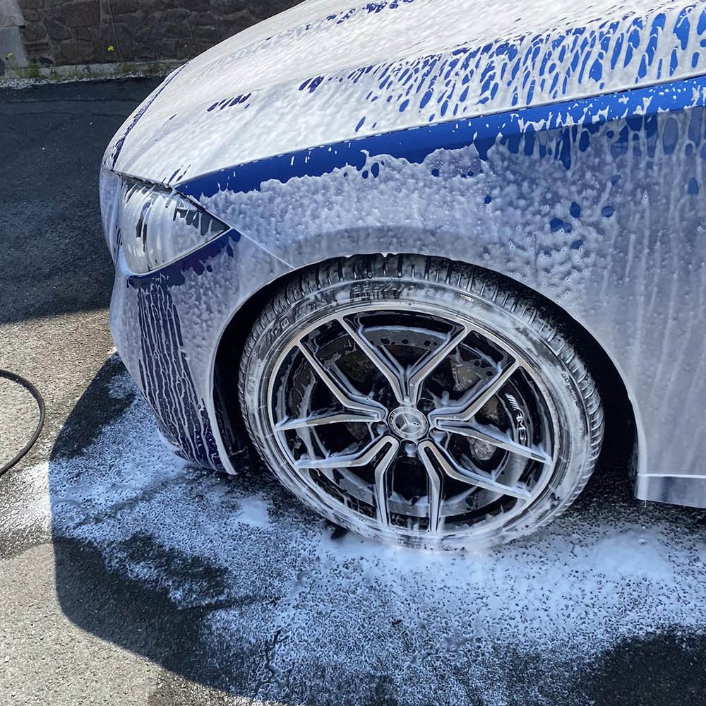 Snow foam on the wheels of a car